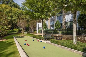 A lawn with a row of red, blue, and white balls.